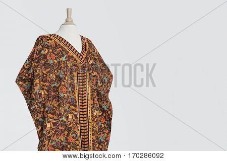Traditional African dashiki on tailor's dummy over gray background