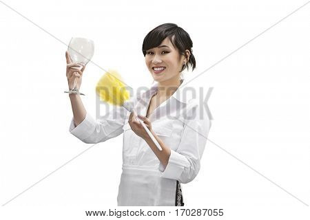 Portrait of a happy female house cleaner dusting glass with feather duster over white background