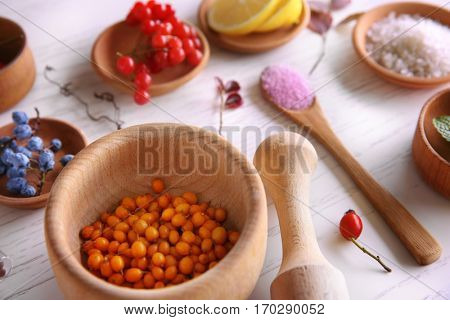 Natural ingredients for homemade cosmetics in wooden bowls, closeup