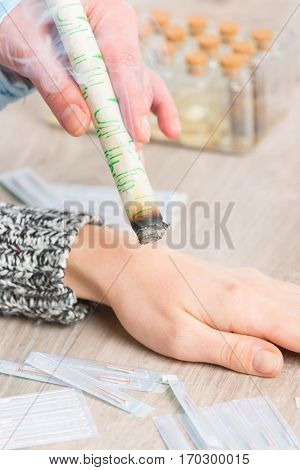 Alternative medicine therapist doing moxa treatment on her client