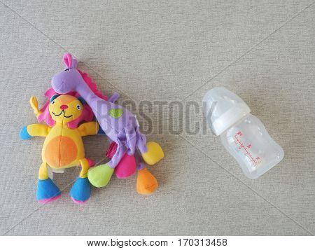 Baby Toy Doll And Empty Milk Bottle