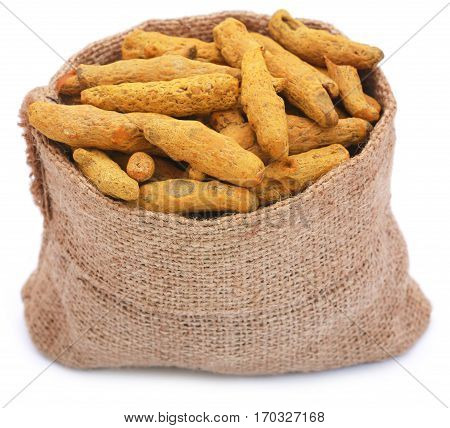 Turmeric in a sack over white background