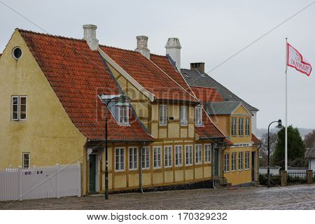 ROSKILDE, DENMARK - DECEMBER 28, 2016: Old houses at the Roskilde cathedral. The farther one was built in 1718 for two poor families
