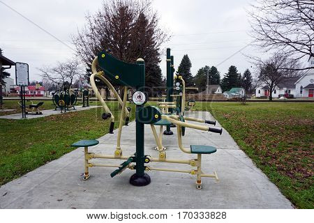 MANCELONA, MICHIGAN / UNITED STATES - NOVEMBER 27, 2016: One may exercise outdoors using fitness equipment in the Railroad Park Fitness Zone, near downtown Mancelona.