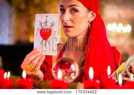Fortuneteller with Tarot cards or esoteric Oracle, sees in the future 