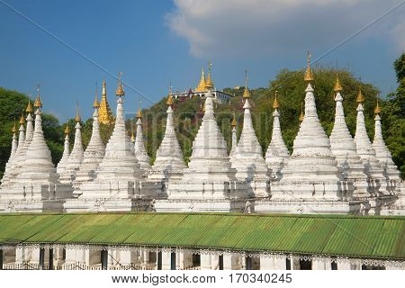 Stupas of the Sandamuni pagoda on the background of the sacred hill. Mandalay, Myanmar