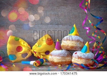 Carnival powdered sugar raised donuts with paper streamers and party bow tie