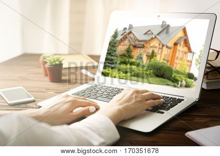 Online shopping concept. Woman looking for house on real estate market website
