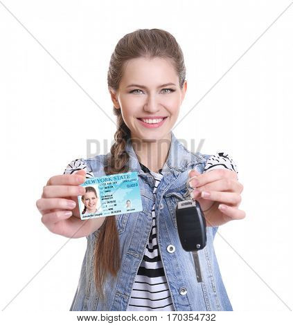 Woman with driving license and car key on white background