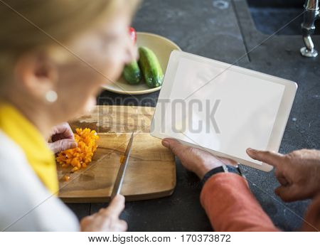 Senior Woman Cooking Food Kitchen Tablet