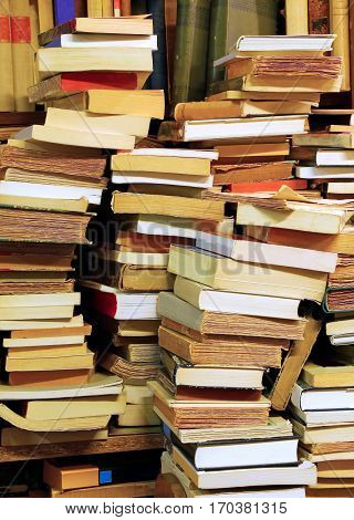 many piles of old books for sale