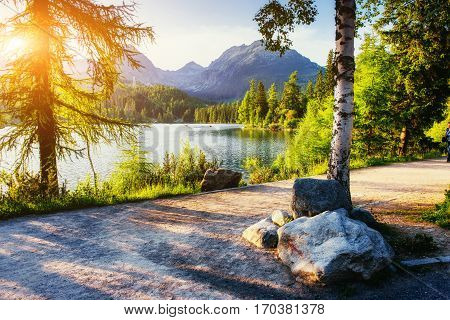 The sunrise over a lake in the park High Tatras. Shtrbske Pleso, Slovakia, Europe.