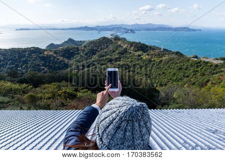 Woman using cellphone to take photo in Awaji island