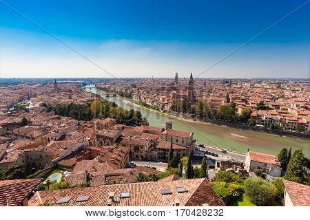 VERONA ITALY- September 09 2016: Panorama of city Verona Italy. Scenery with Adige River Bell towers of churches tile roofs of old houses and the embankment of Adige River.