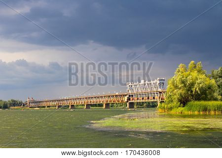 Bridge across river Dnieper in Kremenchug and storm clouds in sky