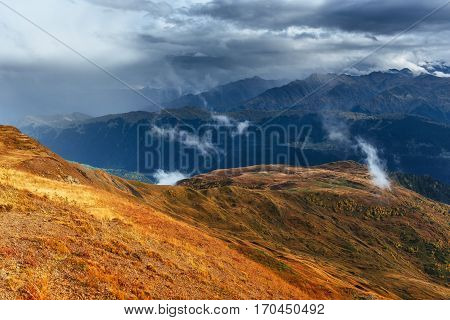 Snow-covered mountains in the mist. Autumn at Koruldi Lake. Europe, Georgia, Upper Svaneti, near mt. Ushba.