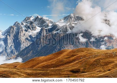 Snow-covered mountains in the mist. Autumn at Koruldi Lake. Europe, Georgia, Upper Svaneti, near mt. Ushba.