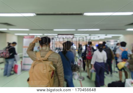 Blurred defocused image of travellers queue at immigration control at airport, for background, color tone effect.