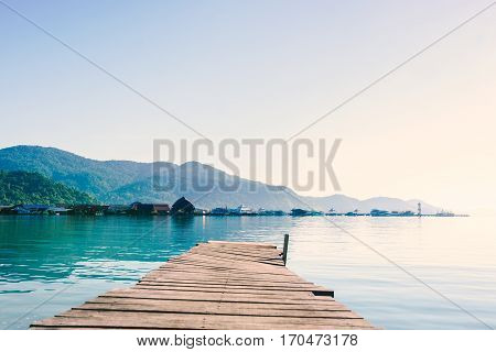 scenic view of the harbour with mountain background against cloudy sky at Bang-Bao Koh Chang Island (Thailand).
