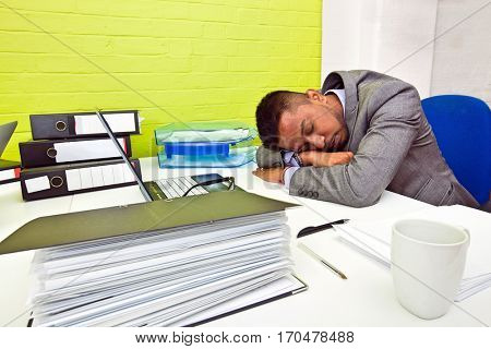 Indian businessman asleep at his desk