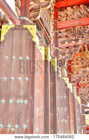 Large wooden doors with golden decorations Todaiji Nara Japan.