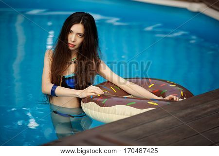Girl in bathing suit standing in a pool of water