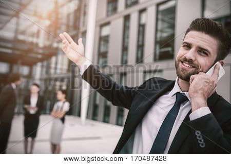Businessman talking on mobile phone in office premises