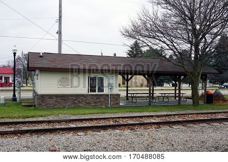 MANCELONA, MICHIGAN / UNITED STATES - NOVEMBER 27, 2016: An historic marker, outside the information booth at Railroad Park, describes the life of the person for whom Mancelona was named.