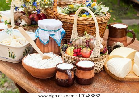 Dairy products on wooden table. Cheese and milk on the table in an earthenware dish. Rural food. Food background.