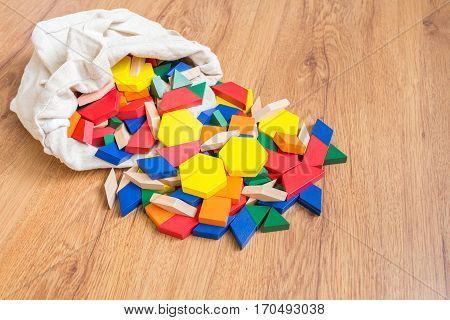 Wooden colored blocks poured out of bag Shallow DOF