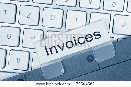 Invoices - folder with text on computer keyboard