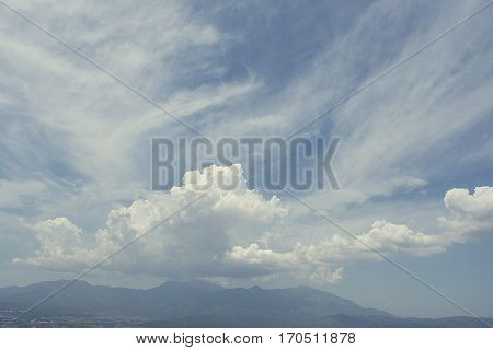 Clouds over distant mountains. The clouds are dancing