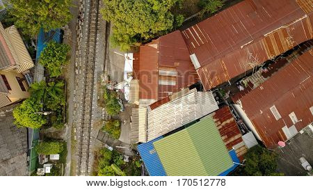 Aerial top view on railway in Bangkok in the slum area of Talat Phlu