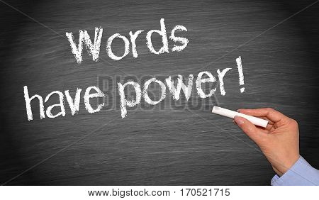 Words have power - female hand writing text on chalkboard