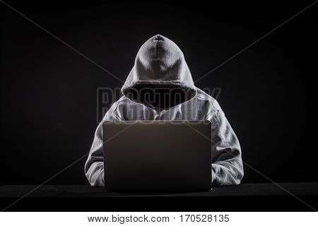hacker on hack a laptop on black background