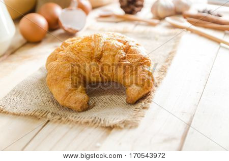 Close up shot of Croissant and bekery ingredients on wooden table
