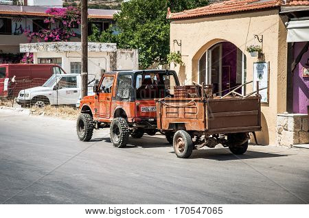 PALEOCHORA, CRTE, GREECE - AUGUST 2016: Jeep car with small cargo trailer at street of Paleochora town