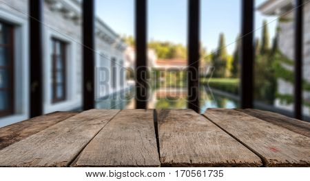 Wood Table Top On Blur Pool With Home Wall And Garden Background In Morning.for Montage Product Disp