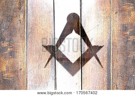Vintage freemason sign on a grunge wooden panel