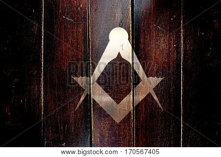 Vintage freemason symbol on a grunge wooden panel