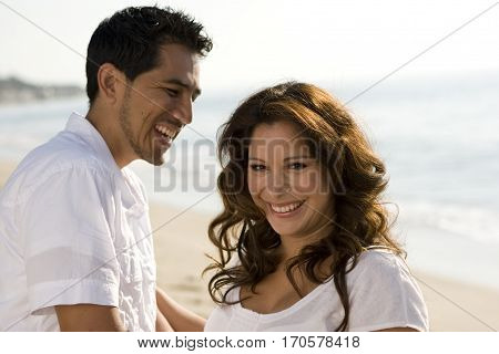 Portrait of a beautiful Hispanic couple laughing and smiling.