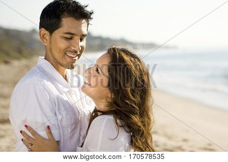 Portrait of a beautiful Hispanic couple laughing and smiling.