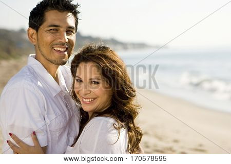 Portrait of a beautiful Hispanic couple laughing and smiling.
