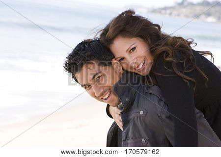 Portrait of a beautiful Hispanic couple laughing and smiling.