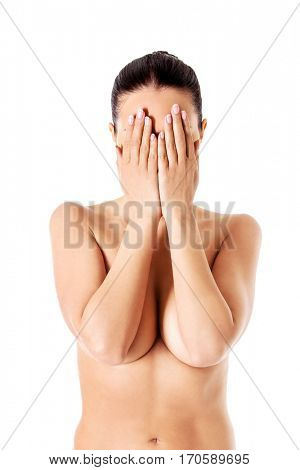 Young woman covering her face with her hands.