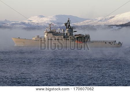 battleship sailing fog sea background snowy mountains