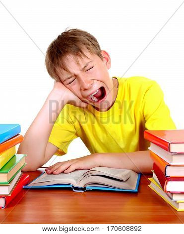 Tired Kid Yawn at the School Desk with a Books on the White Background