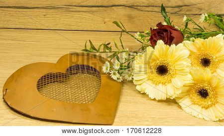 Heart from metal with a bouquet of flowers