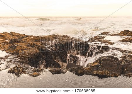 Ocean beach waves at Thor's Well in Cape Perpetua Oregon Coast USA.