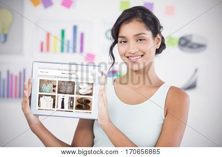 Happy businesswoman showing digital tablet in creative office against website frontpage